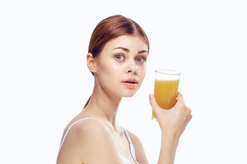 Beautiful young woman on white isolated background holds a glass of fresh juice, diet, slimming, proper nutrition