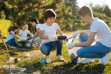 Kind friends gathering glass rubbish