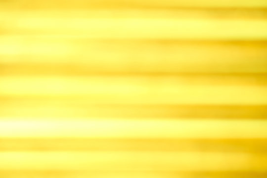 Hintergrund in gelb mit parallel verlaufenden unscharfen Linien