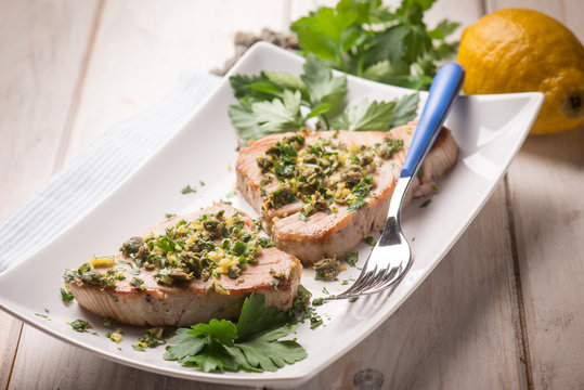 grilled tuna with caper and lemon peel, selective focus