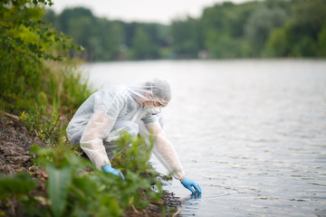 Ecologist takes sample of water