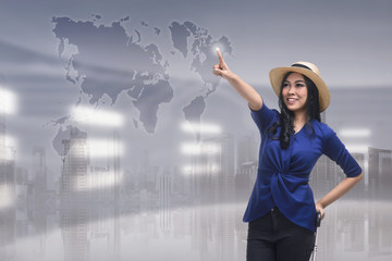 Beutiful asian woman touching travel destination on virtual screen