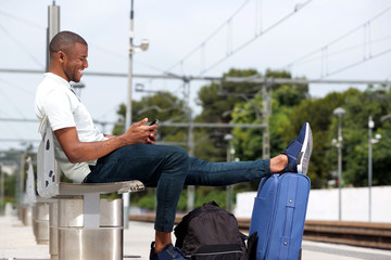Fototapeta na wymiar Young guy waiting at railway station