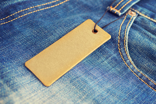 Blank Label Price Tag Mockup On Blue Jeans.