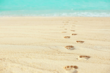 Human footprints on beach sand at resort