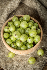 Fresh gooseberry in a wooden bowl.