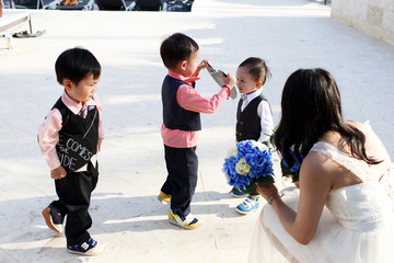Fototapeta premium Little boys in black suits play outside