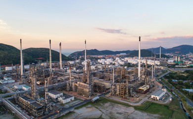Aerial view Oil refinery with a background of mountains and sky.The factory is located in the middle of nature and no emissions. The area around the air pure.