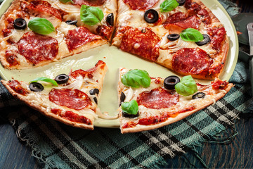 Pizza pepperoni with olives served