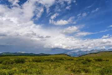 Fototapeta na wymiar mountains sky clouds meadow