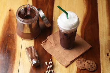 Ice cocoa soft drink on wood floor and topping