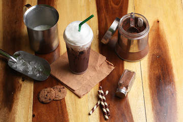 Ice cocoa soft drink on wood floor and topping