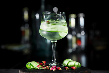 Green fresh cucumber lemonade cocktail on dark background