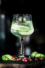 Green fresh cucumber lemonade cocktail on dark background