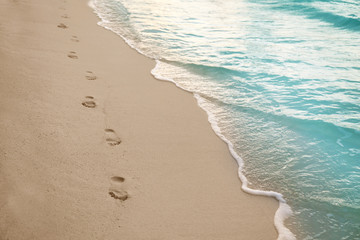 Human footprints on beach sand at resort