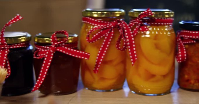 Jars of pestos, jam and preserves on display counter