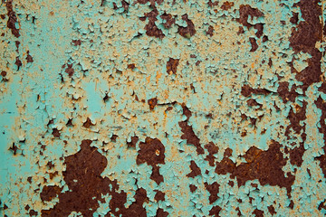 Rusty metal surface with cracked green paint