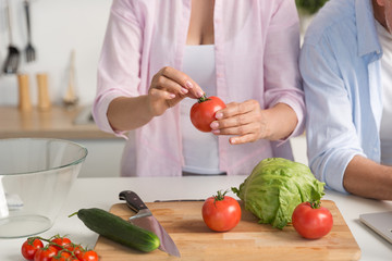 Cropped picture of mature loving couple family cooking.