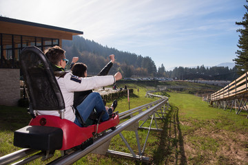 couple enjoys driving on alpine coaster