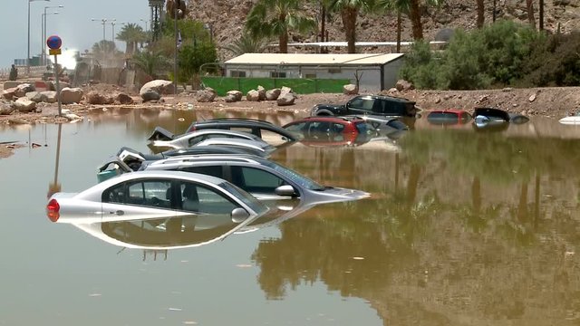 Flooded Cars in the Parking Road in Desert. Global Warming
Deep Waters. Flooding Nature After Heavy Rainy Day. 