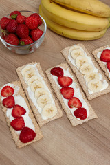 Healthy food. Fruit cut into bread and biscuits. A delicious dessert. Strawberry. Bananas. Fruits on a wooden background.Healthy food. Fruit cut into bread and biscuits. 