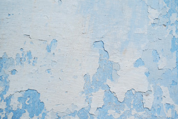 White blue wall with scratches and cracks