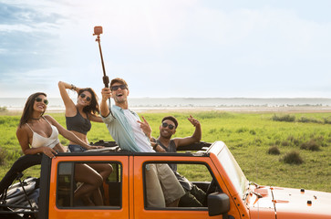 Happy group of friends taking selfie