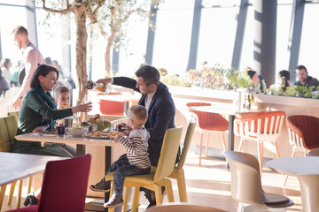 Young parents enjoying lunch time with their children