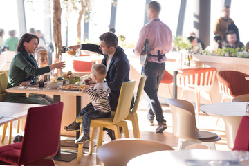 Young parents enjoying lunch time with their children