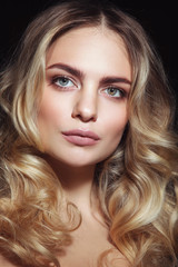 Young beautiful woman with clean make-up and blonde curly hair