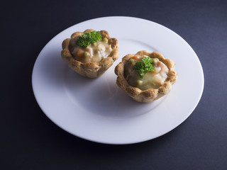 Savory Danish tartlets (tarteletter) made from puff pastry, filled with a creamy chicken, asparagus...