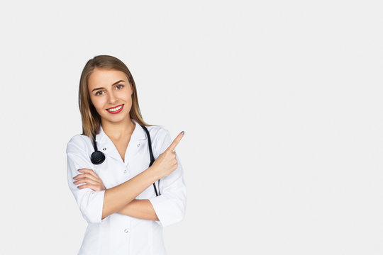Female doctor holding arms folded pointing