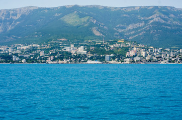 Fototapeta premium The city by the sea the sky is reflected in the water
