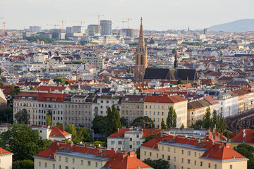 Aerial view of the district Landstrasse (third municipal district of Vienna) with the St.Othmar Church in the center and a lot of construction cranes on the horizon. Vienna, Austria.