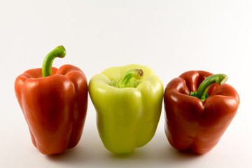 colored peppers over white background