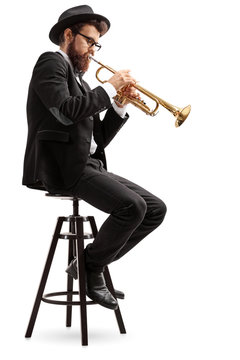 Trumpet player sitting on a chair