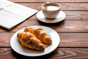 Businessman morning cup of coffee at home with newspaper