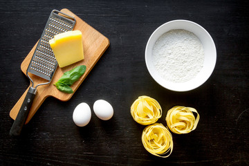 cooking process of pasta on dark background top view