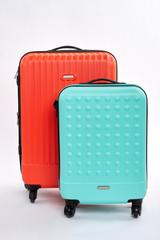 Bright suitcases for travelling. Front view of travel luggage.