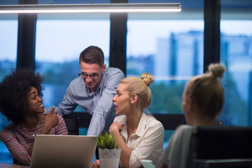 Multiethnic startup business team in night office