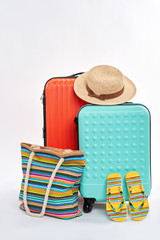 Summer travelling accessories. Suitcases and clothes. Summer vacation concept.