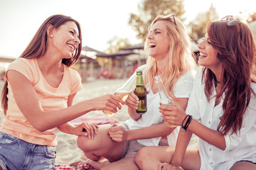 Three beautiful girls having fun on the beach