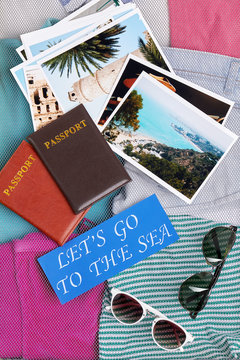Different things for going abroad. Glasses, passports,clothes. Photos of resorts.