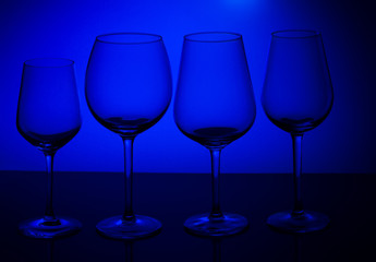 Row of wine glasses on blue background