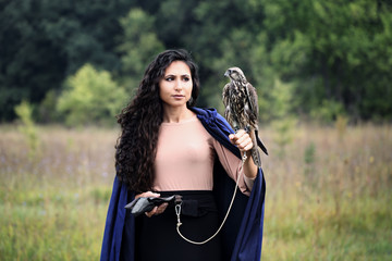 woman holding a falcon