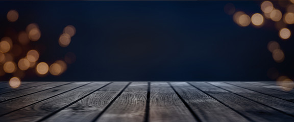Dark blue bokeh background with wooden stage