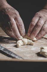 Senior woman, grandma, rolling fresh homemade croissants