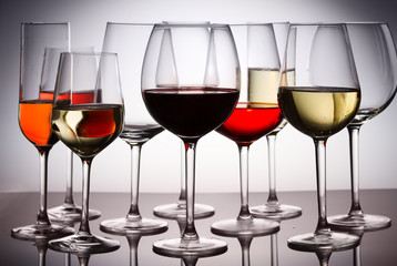 Set of party hight wine glasses with red, white and rose wine