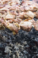 Skewers of pork or meat fried on a barbecue on the grill, barbecue