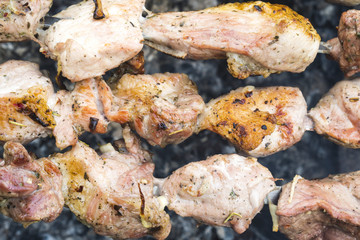 Skewers of pork or meat fried on a barbecue on the grill, barbecue